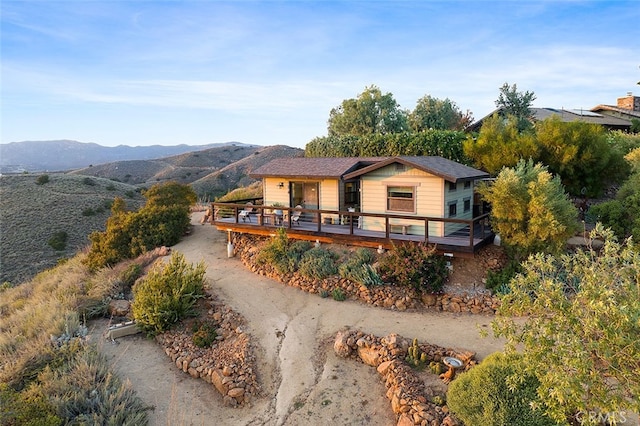 view of front of property featuring a deck with mountain view