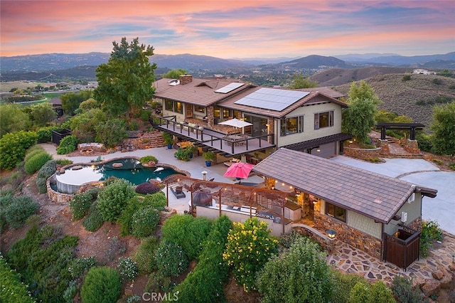 aerial view at dusk featuring a mountain view