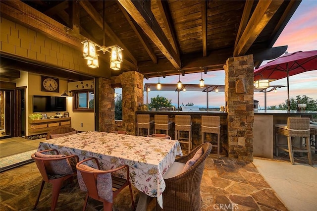 dining area featuring wooden ceiling and vaulted ceiling with beams