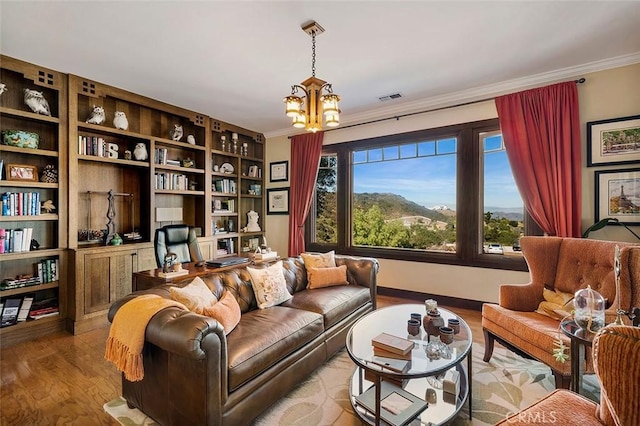 sitting room with a wealth of natural light, crown molding, a notable chandelier, and light wood-type flooring