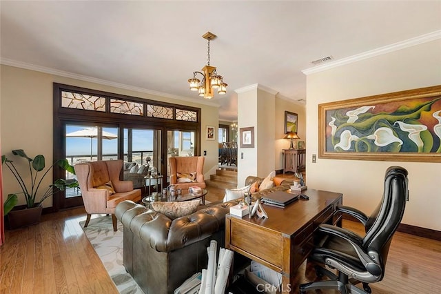 living room featuring ornamental molding, light hardwood / wood-style floors, and a chandelier