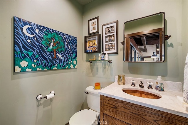 bathroom with toilet and vanity