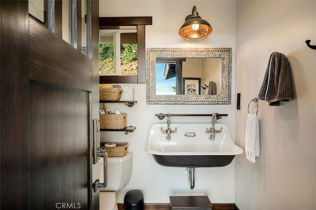 bathroom featuring sink and toilet