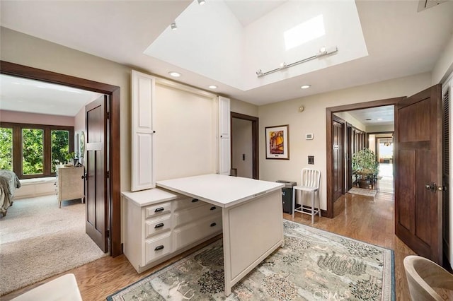 office area featuring rail lighting and light hardwood / wood-style flooring