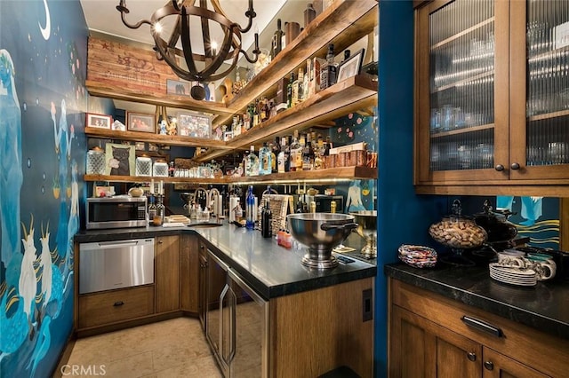 bar with sink and a chandelier