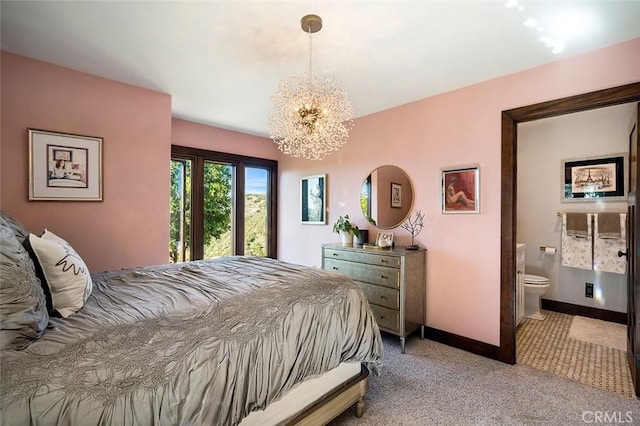 bedroom featuring light colored carpet, a chandelier, and connected bathroom