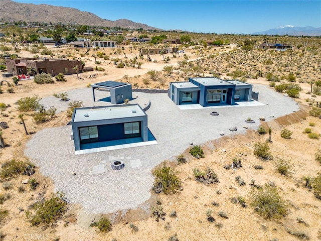 birds eye view of property with a mountain view