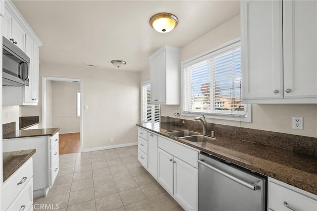 kitchen featuring sink, white cabinets, and stainless steel appliances