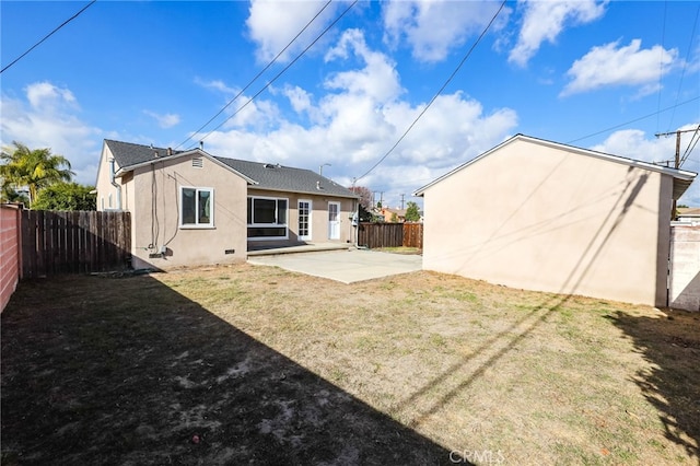 back of property featuring a lawn and a patio