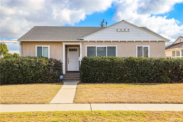 bungalow-style house with a front yard