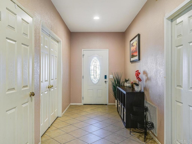 entryway with light tile patterned flooring