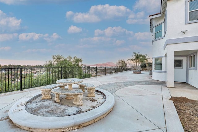 view of patio featuring a mountain view and an outdoor fire pit