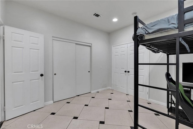 unfurnished bedroom with light tile patterned floors