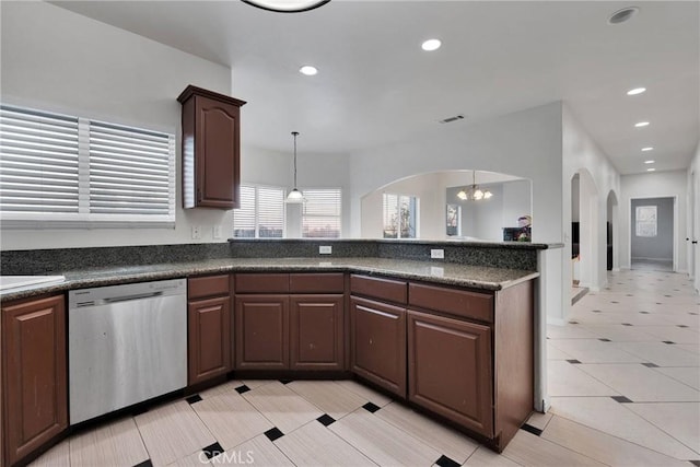 kitchen with decorative light fixtures, dark brown cabinetry, stainless steel dishwasher, and a notable chandelier