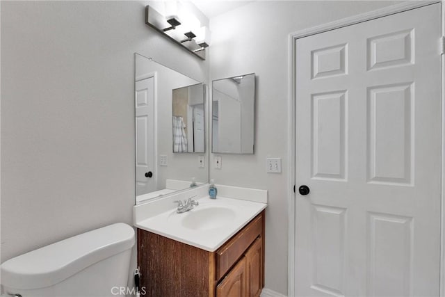 bathroom featuring toilet and vanity