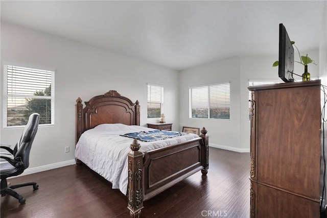 bedroom with dark hardwood / wood-style floors