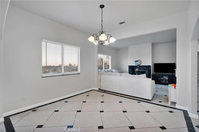 tiled living room with a notable chandelier