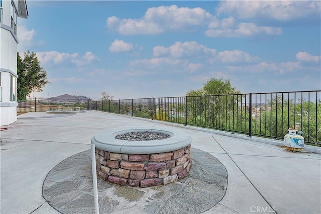 view of patio with a fire pit