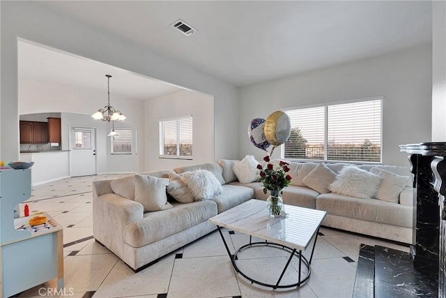 tiled living room with a chandelier