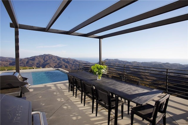 exterior space featuring a pergola, a mountain view, and an outdoor bar