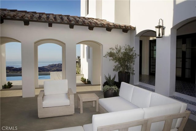 view of patio with an outdoor living space and a water view