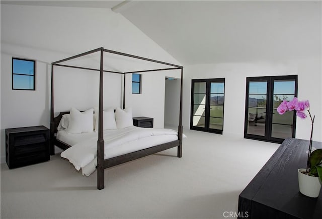 carpeted bedroom featuring french doors, vaulted ceiling with beams, and multiple windows