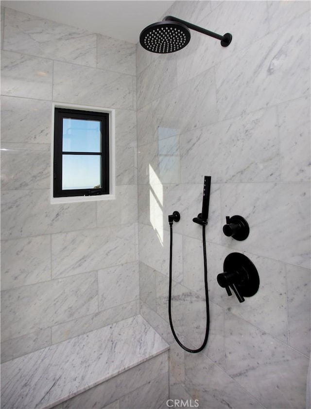 bathroom with tiled shower