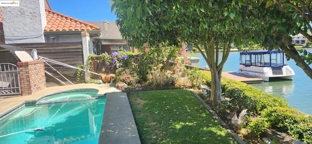 view of swimming pool with a water view and an in ground hot tub