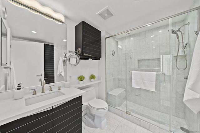 bathroom with an enclosed shower, vanity, and toilet