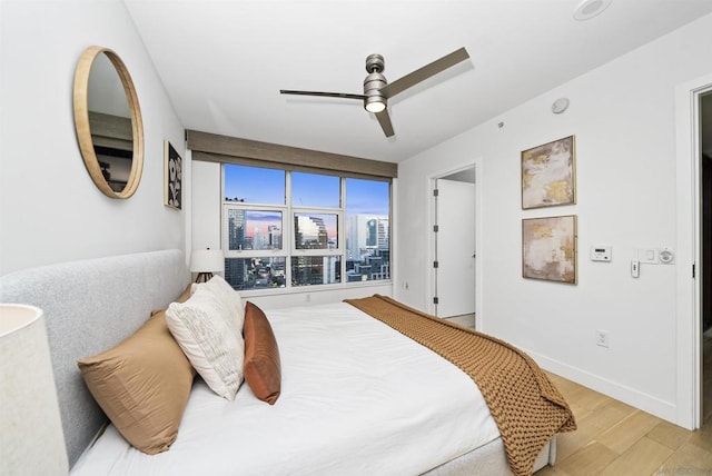 bedroom with ceiling fan and hardwood / wood-style floors