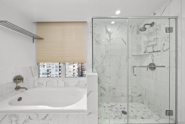 bathroom with shower with separate bathtub