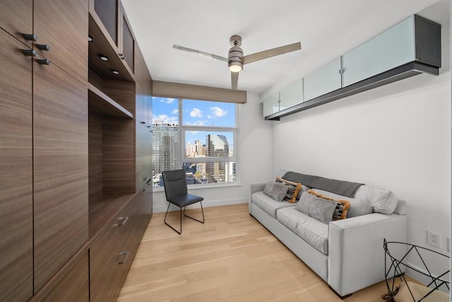 living room featuring light wood-type flooring and ceiling fan