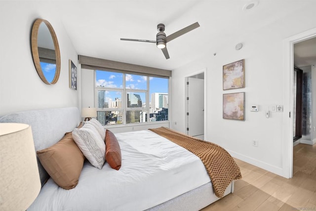 bedroom with light wood-type flooring and ceiling fan