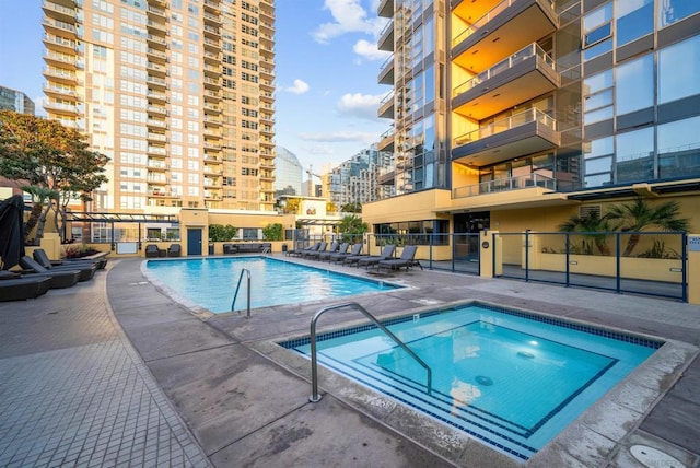 view of pool with a patio area and a hot tub