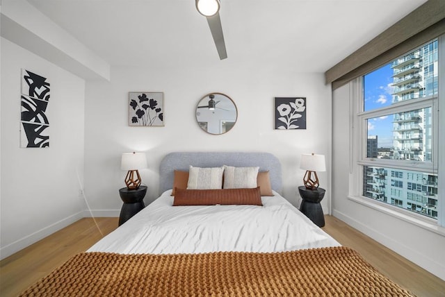 bedroom with ceiling fan and light hardwood / wood-style flooring