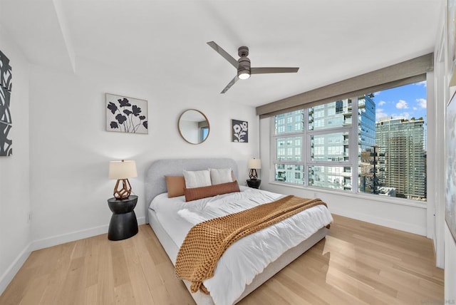 bedroom featuring ceiling fan and light hardwood / wood-style flooring