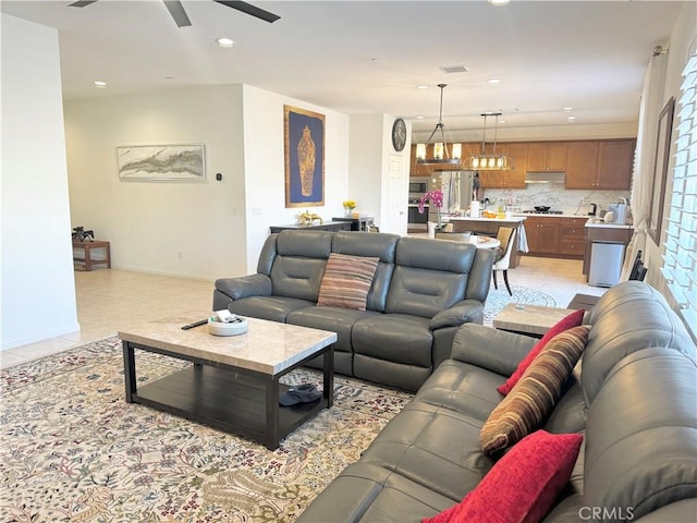 tiled living room with ceiling fan