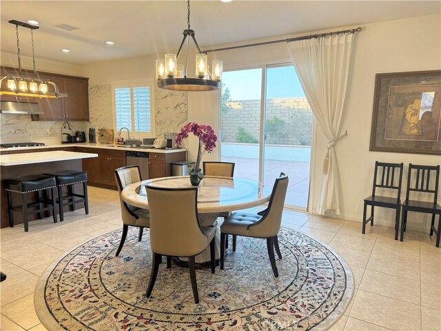 tiled dining area with sink and a notable chandelier