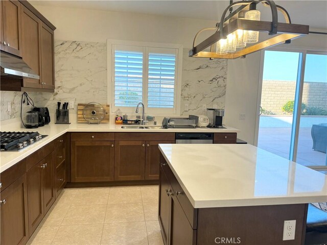 kitchen featuring decorative backsplash, sink, light tile patterned floors, and stainless steel appliances