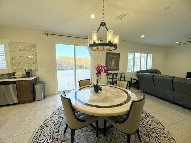 dining room with an inviting chandelier and light tile patterned floors