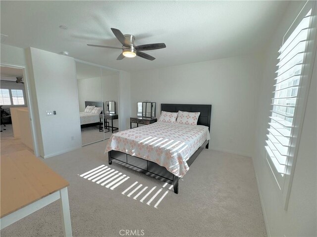 bedroom with ceiling fan and light carpet