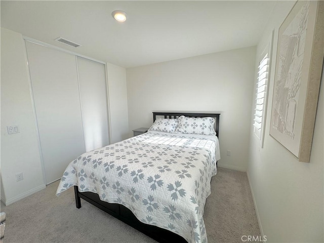 bedroom featuring a closet and light carpet