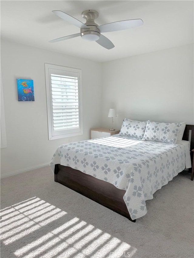 bedroom featuring light colored carpet and ceiling fan