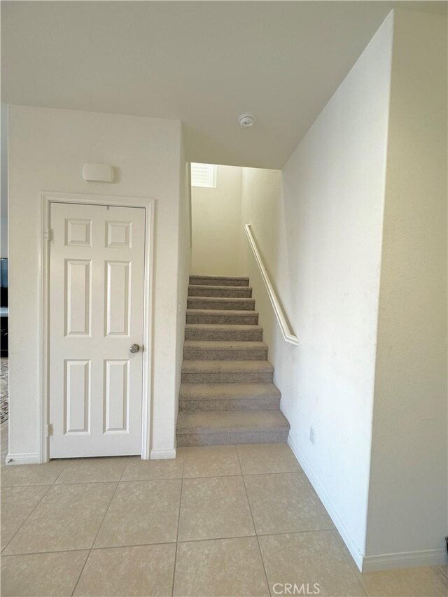 staircase featuring tile patterned floors