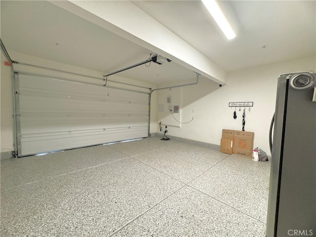 garage with refrigerator and a garage door opener