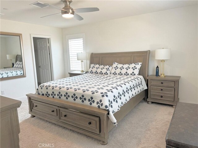 bedroom featuring ceiling fan and light carpet