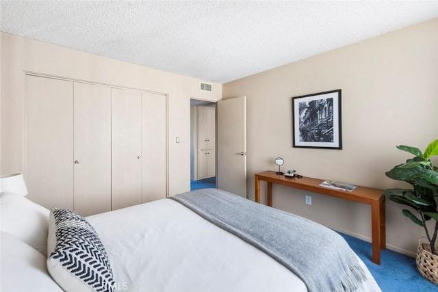 bedroom featuring a textured ceiling, a closet, and carpet flooring