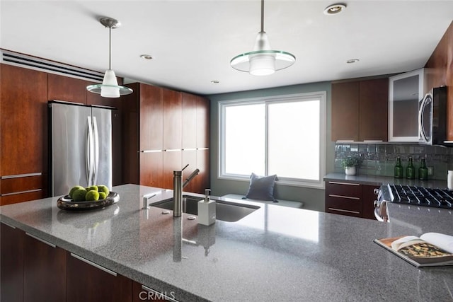 338 N Clybourn Ave, Burbank, CA 91505 - kitchen with stainless steel appliances, a sink, decorative light fixtures, dark stone countertops, and recessed lighting