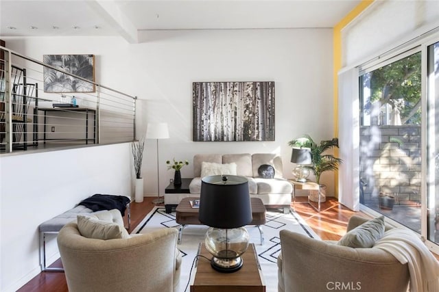 living room with hardwood / wood-style flooring and beamed ceiling