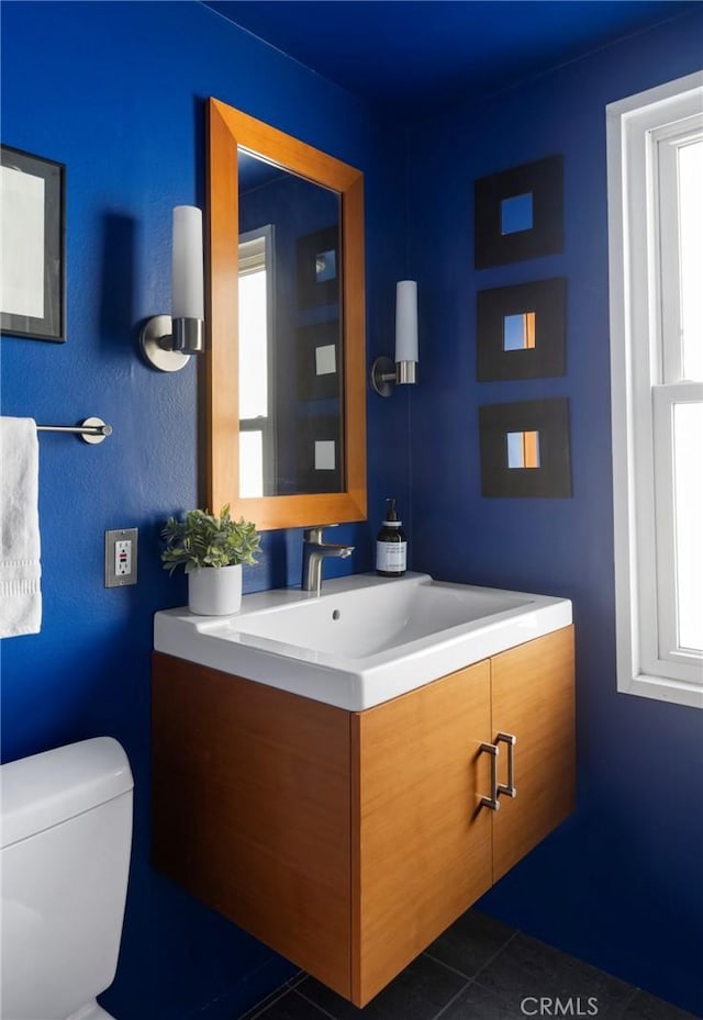 bathroom with a healthy amount of sunlight, vanity, and tile patterned floors